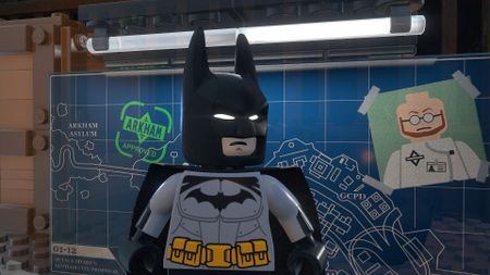 Batman in his Arkham costume poses in front of a map of Gotham's Arkham City and Arkham Asylum
