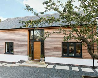 dark gravel driveway with paved stepping stones