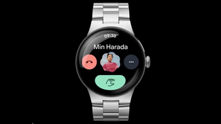 A render of the Pixel Watch 4 showing an incoming phone call screen, with the green Answer button showing a Double Pinch gesture animation.