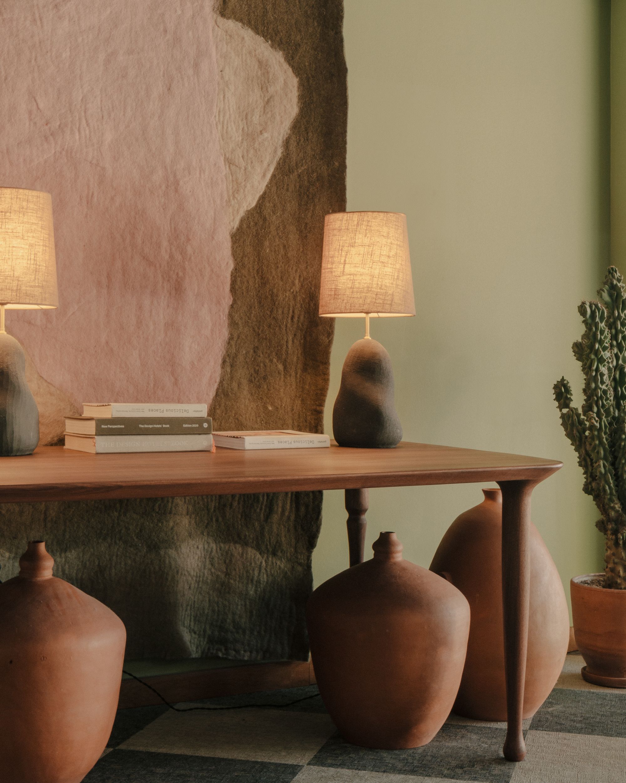 A series of pictures depicting the interior and exterior grounds of a sprawling resort, immersed in nature, between vineyards, gardens, and spa pools, and decorated with crafty artifacts.