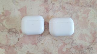 A side by side comparison of the AirPods 3 and AirPods Pro wireless charging cases
