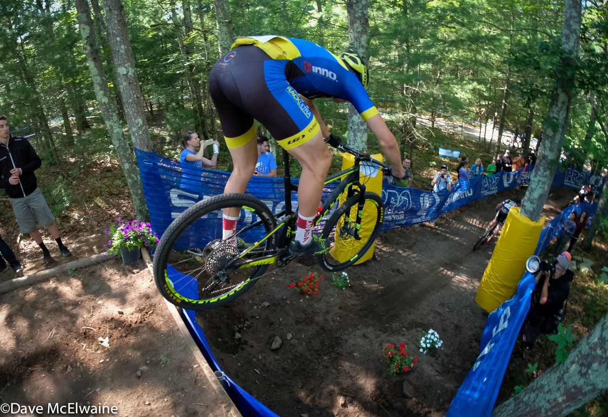 A rider flies off the Shimano Jump during lap three
