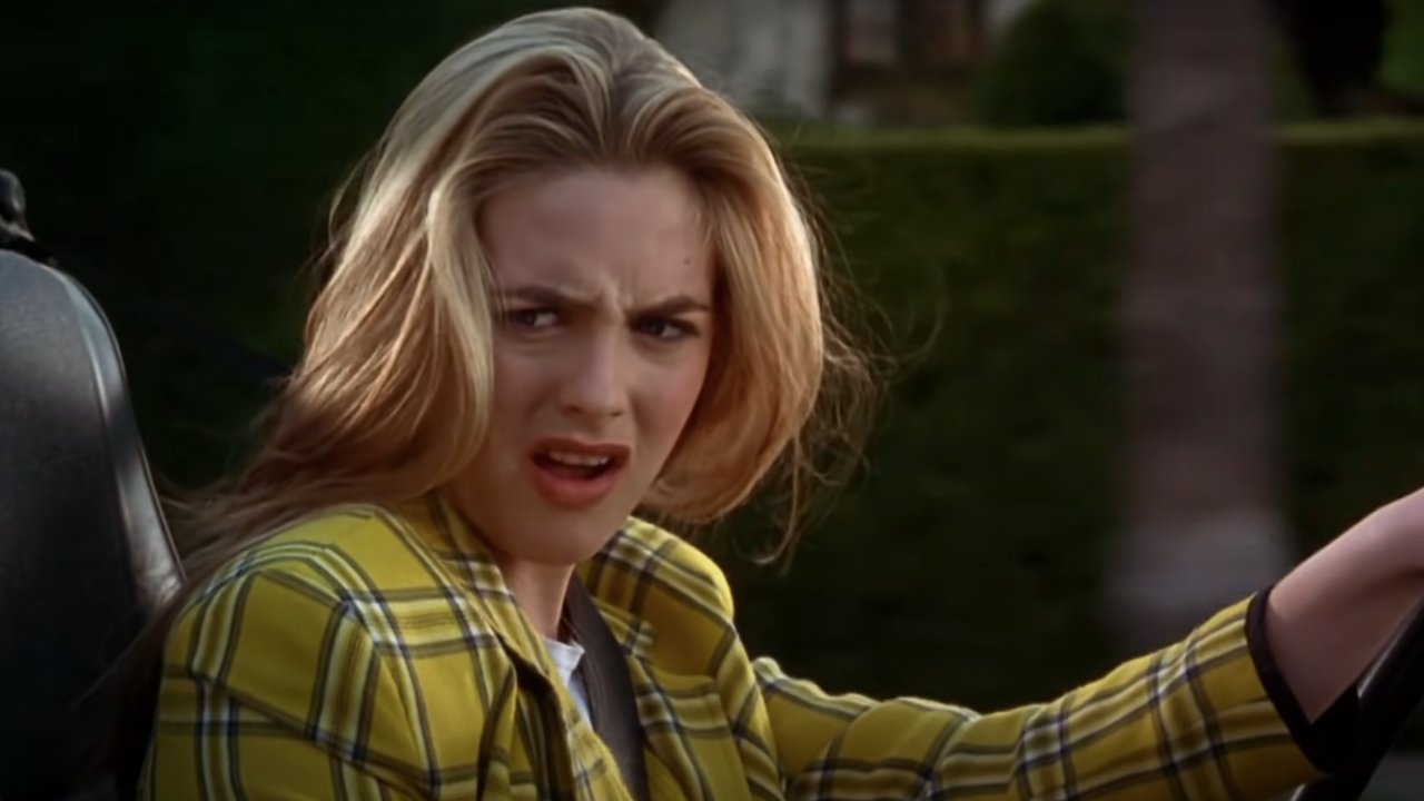 Alicia Silverstone looks disgusted behind the wheel in Clueless.