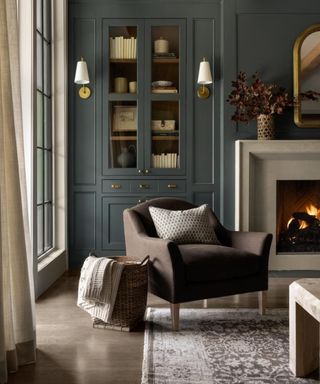 fall scheme blue living room with built in shelving and storage and a white stone fireplace