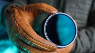 A photographer adjusts the PolarPro Arctic CP filter while wearing gloves