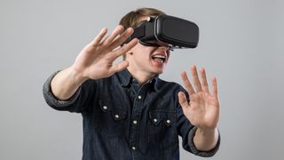 Man with hands out using a VR headset.