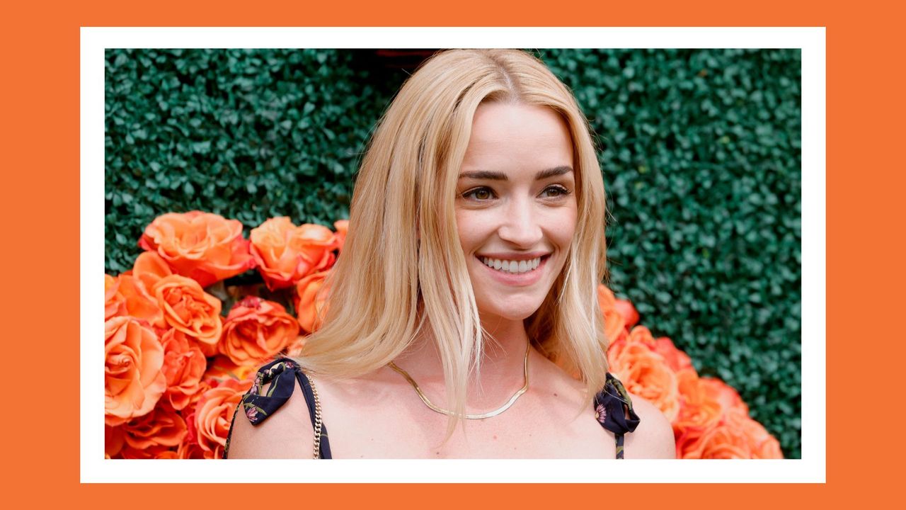 brianne howey headshot from an event on an orange background