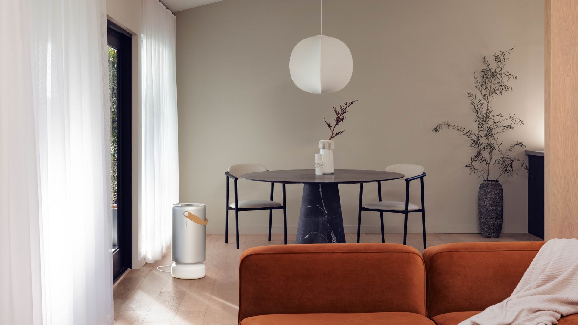 Molekule Air Purifier Pro in an open plan living and dining room with a neutral design