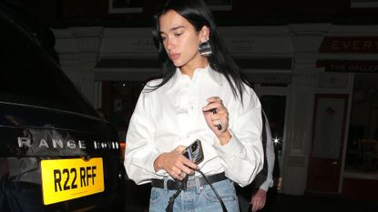 Dua Lipa wears white shirts, jeans and ballet flats out in London