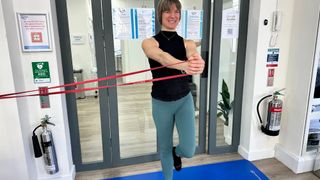 Woman performing a Pallof press with resistance bands