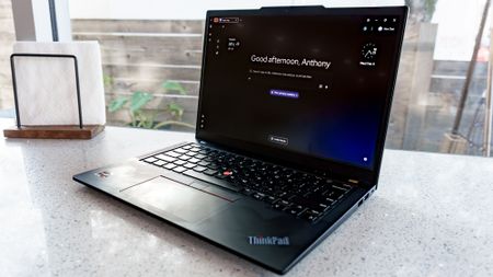 A laptop on a countertop with Norton's Neo browser open showing its Magic Page home screen