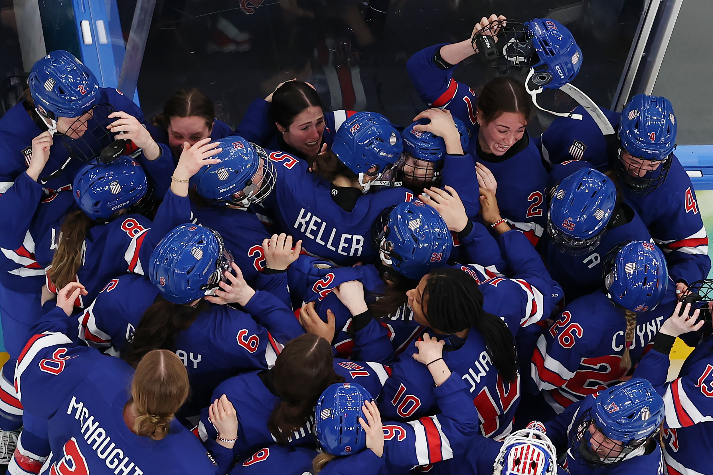 MILAN, ITALY - FEBRUARY 19: (EDITOR'S NOTE: Image was captured using a remote camera positioned above the field of play.) Players of Team United States celebrate winning the gold medals after the team's 2-1 overtime victory in the overtime during the Women's Gold Medal match between the United States and Canada on day 13 of the Milano Cortina 2026 Winter Olympic games at Milano Santagiulia Ice Hockey Arena on February 19, 2026 in Milan, Italy. (Photo by Jared C. Tilton/Getty Images)