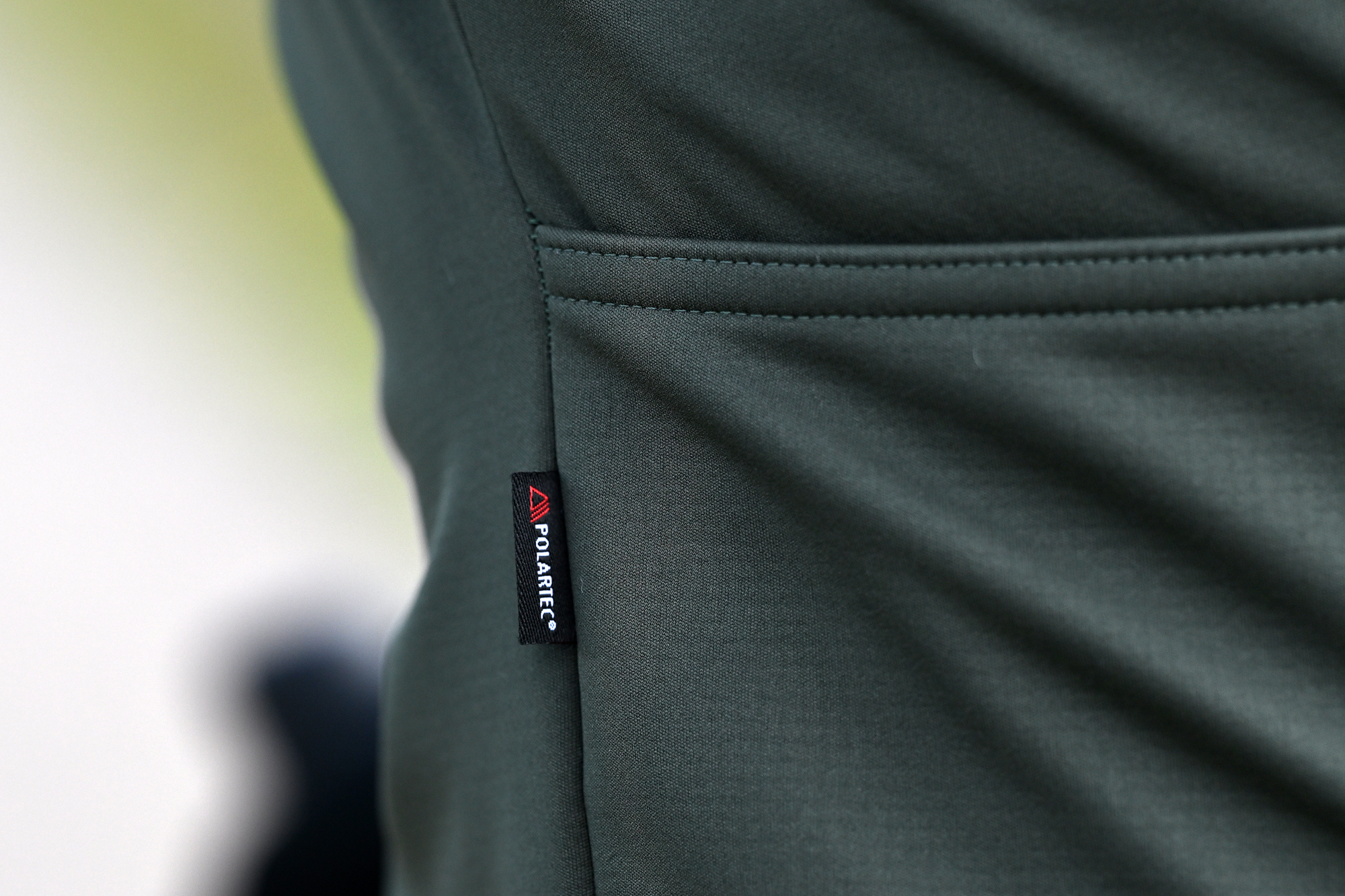 close up of a green jacket showing the Polartec label