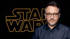 Colin Trevorrow in front of the Star Wars logo