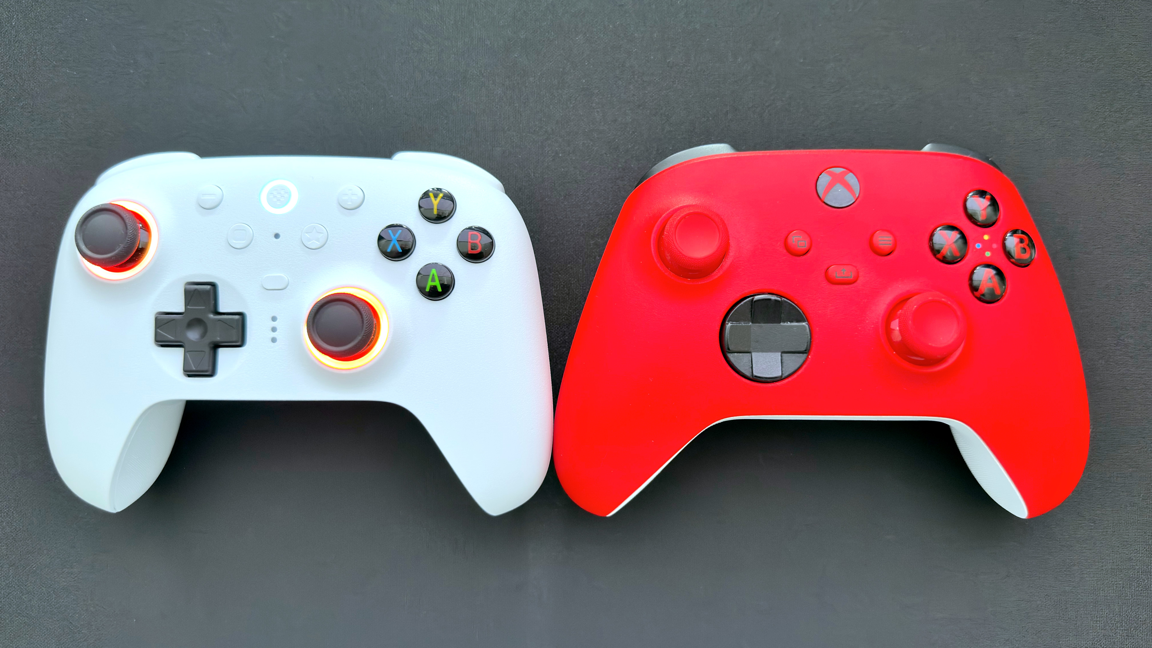 A photo of the 8BitDo Ultimate 2 Wireless game controller next to a Microsoft Xbox controller