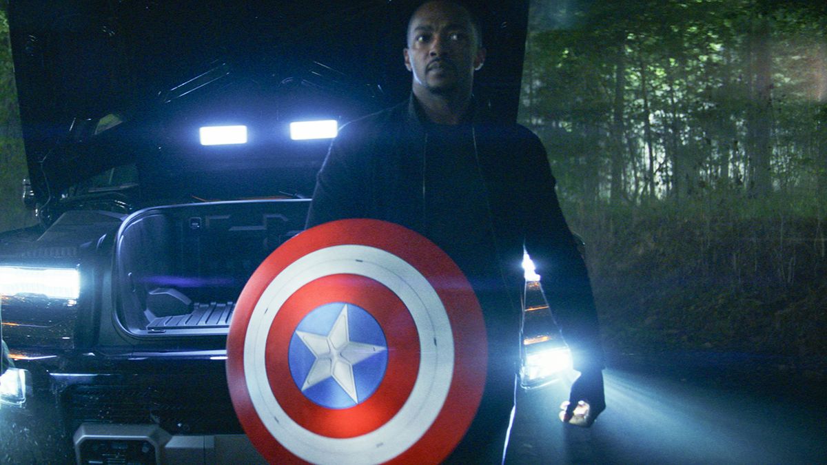 Sam Wilson holding Captain America&#039;s shield in front of a truck at night in Captain America: Brave New World