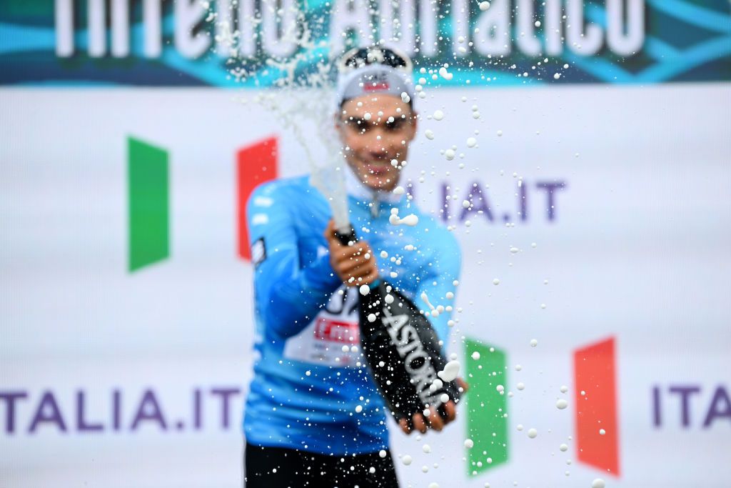LIDO DI CAMAIORE ITALY MARCH 04 Juan Ayuso of Spain and UAE Emirates Team celebrates at podium as Blue Leader Jersey winner during the 59th TirrenoAdriatico 2024 Stage 1 a 10km individual trial time from Lido di Camaiore to Lido di Camaiore UCIWT on March 04 2024 in Lido di Camaiore Italy Photo by Tim de WaeleGetty Images