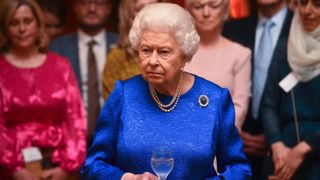 Queen Elizabeth II attends a reception to celebrate the work of the Queen Elizabeth Diamond Jubilee Trust