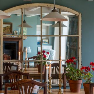 A dining room with a heavy antique mirror