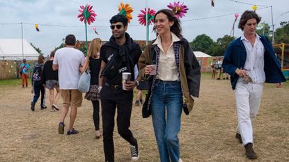 Alexa Chung wears wellington boots and a blue mini dress at Glastonbury