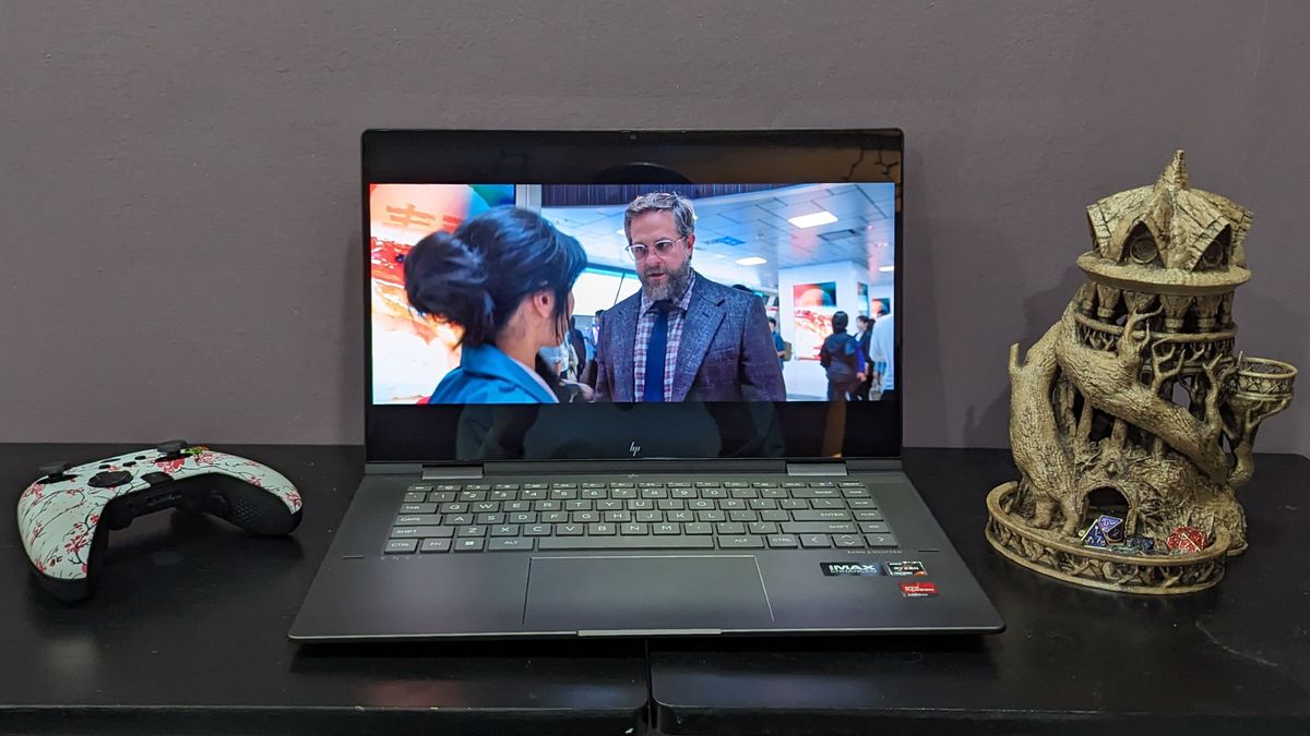 The HP Envy x360 open-facing, with a video streaming on the display.