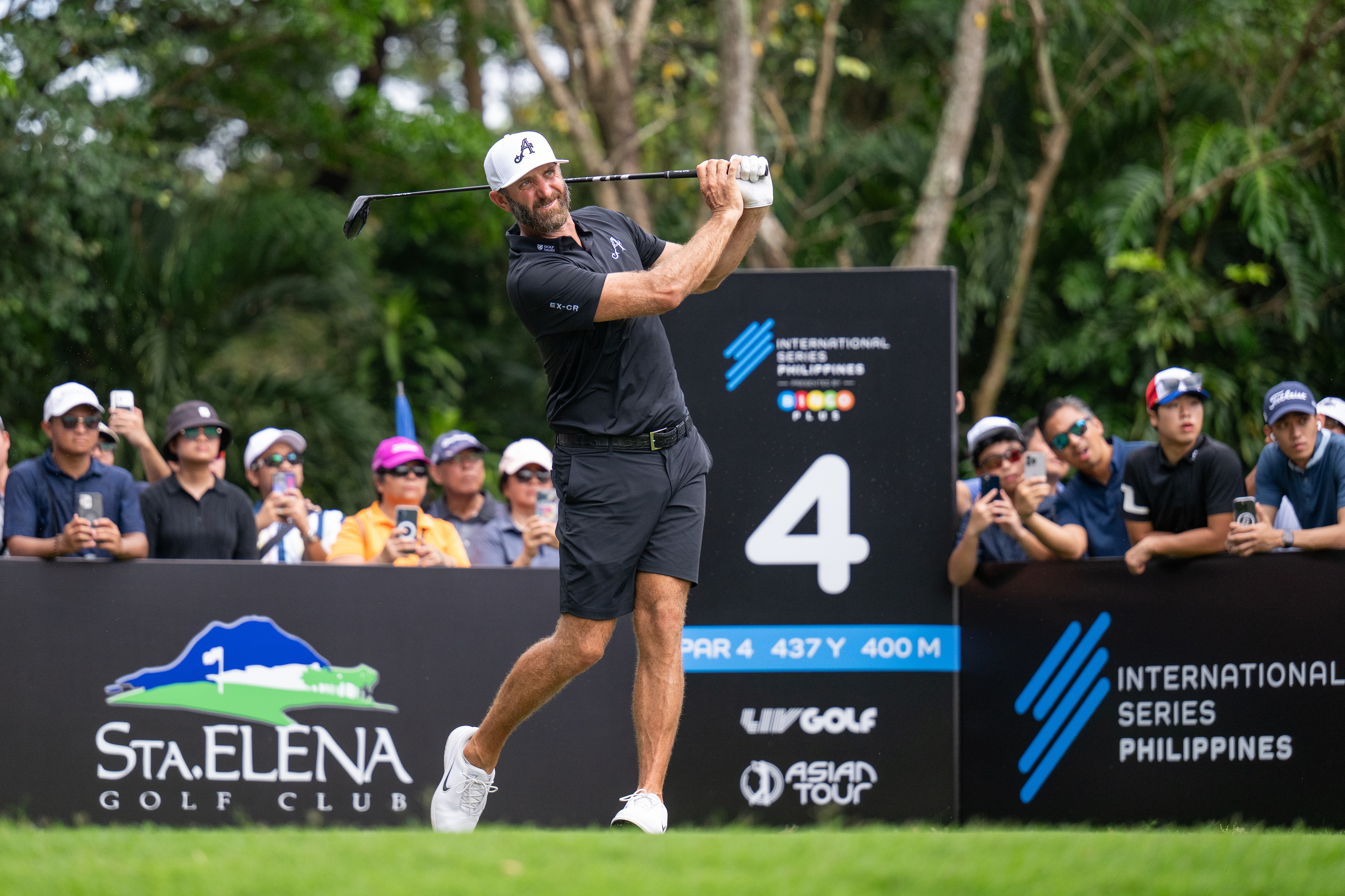 Dustin Johnson holds his finish on a drive at the International Series Philippines