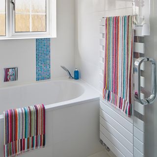 bathroom with white wall and towel