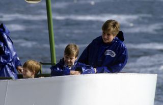 Prince Harry and Prince William as children on a boat with mother Princess Diana