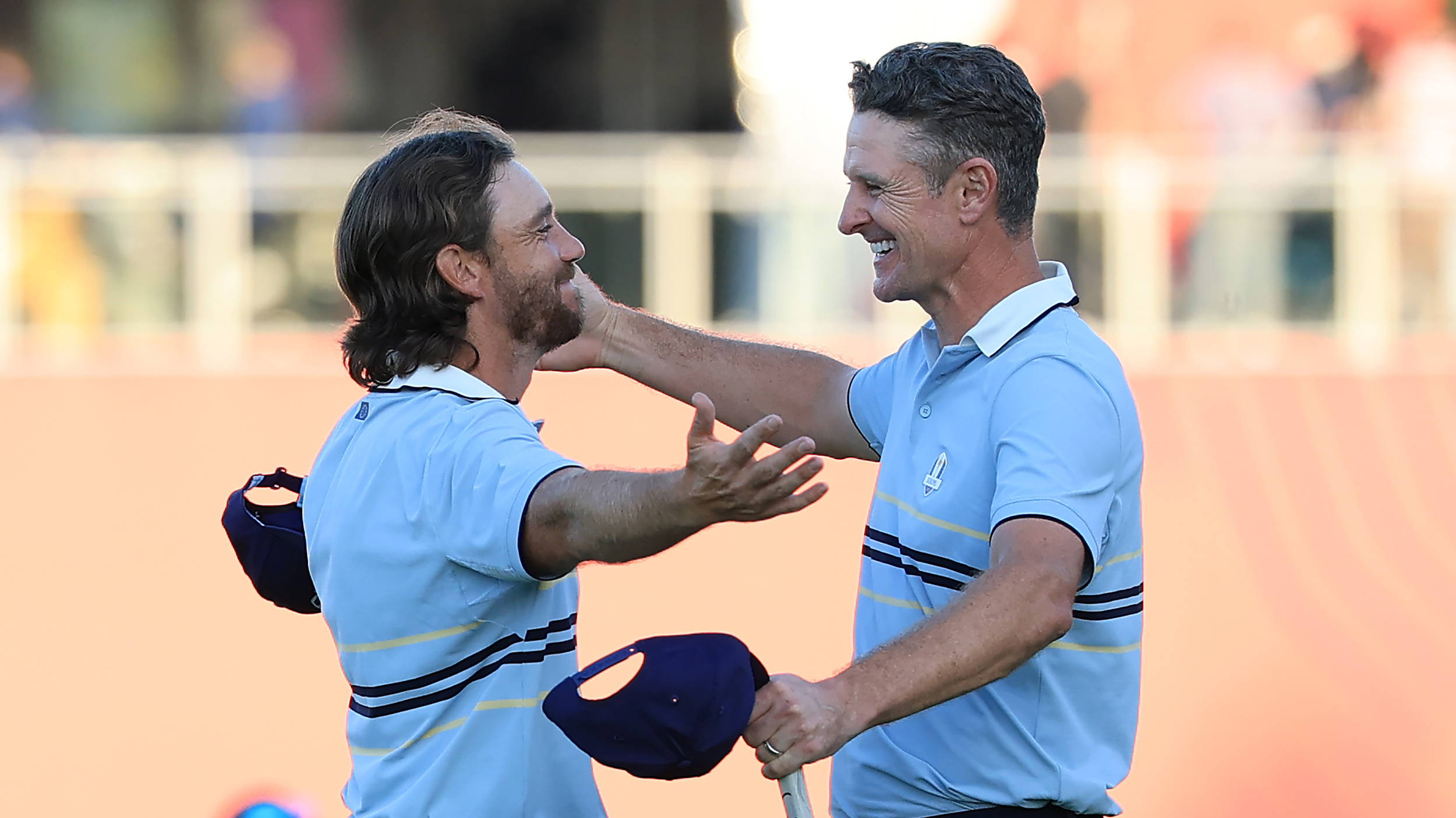 Tommy Fleetwood and Justin Rose embrace during day one of the 2025 Ryder Cup