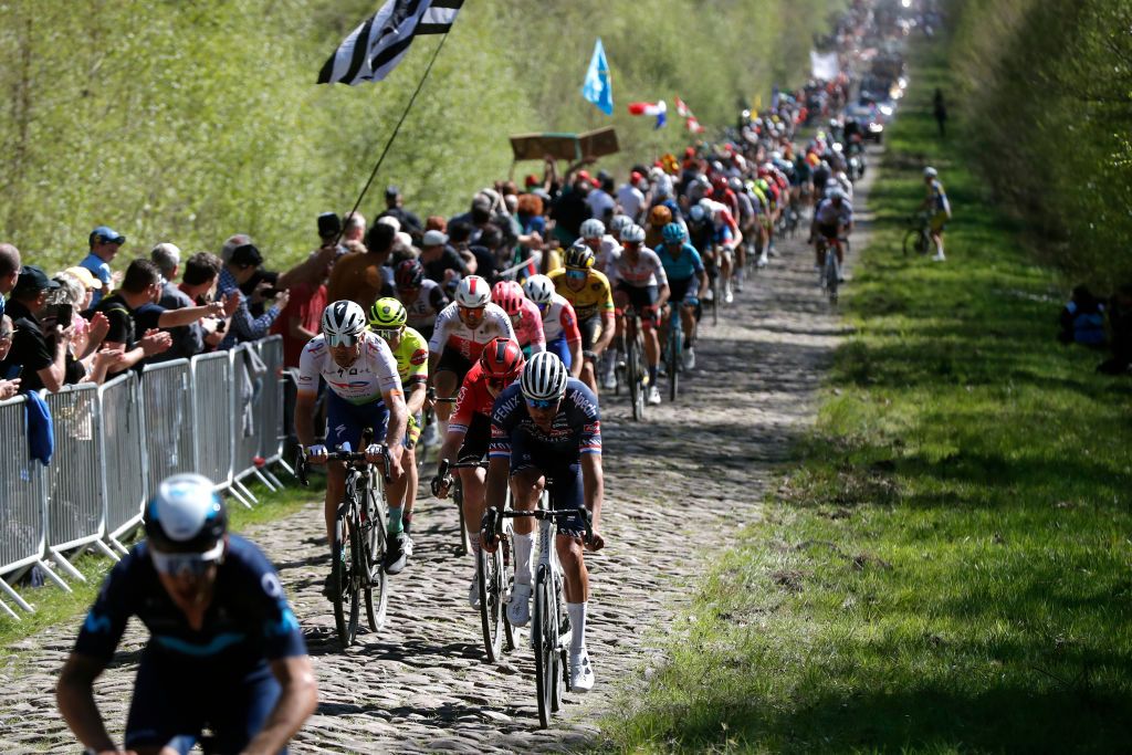 ROUBAIX FRANCE APRIL 17 LR Maciej Bodnar of Poland and Team Total Energies and Mathieu Van Der Poel of Netherlands and Team AlpecinFenix compete passing through La Troue dArenberg cobblestones sector during the 119th ParisRoubaix 2022 Mens Elite a 2572km one day race from Compigne to Roubaix ParisRoubaix WorldTour on April 17 2022 in Roubaix France Photo by Bas CzerwinskiGetty Images
