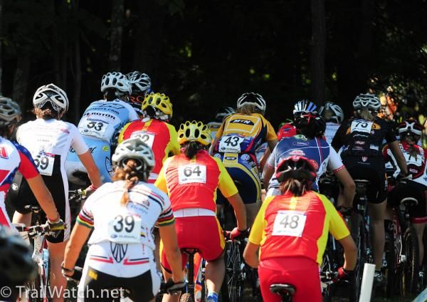 Elite women reach a log jam as they enter singletrack