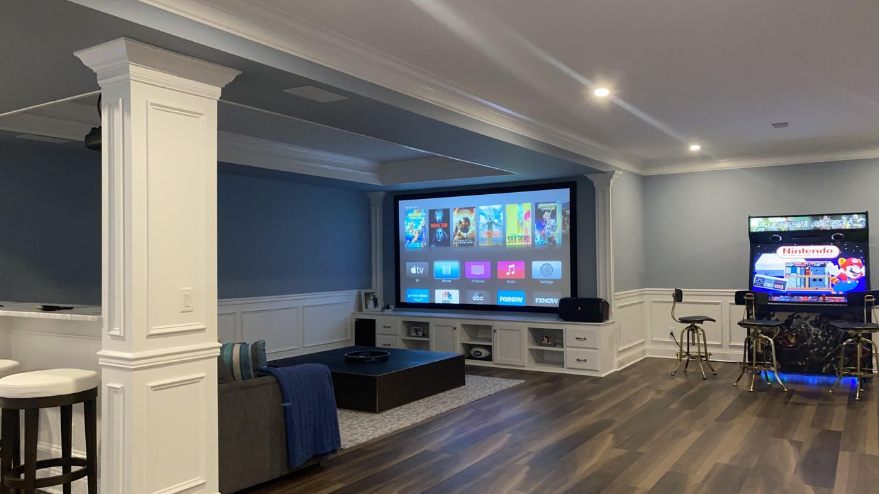 Home theater New Jersey basement showing projector screen and Nintendo arcade game