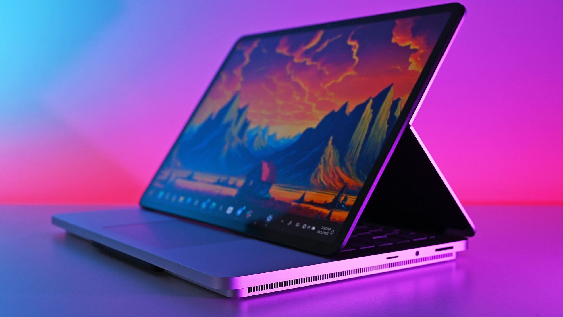 Side profile of a Microsoft Surface Laptop Studio 2 in stage mode, displaying a colorful mountain sunset desktop wallpaper against a vibrant blue and pink gradient studio background.