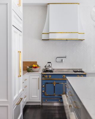 white kitchen with blue oven by Studio Munroe