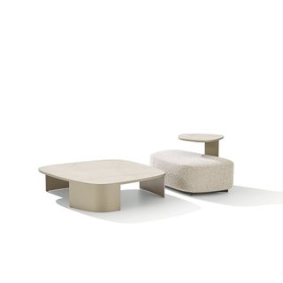 A white marble coffee table and a white upholstered seat by Poliform