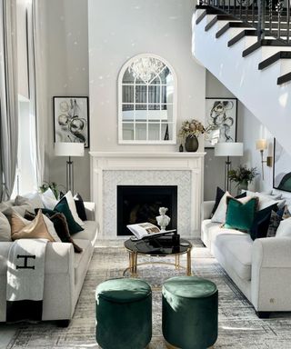 A living room with white, black, and green luxe decor