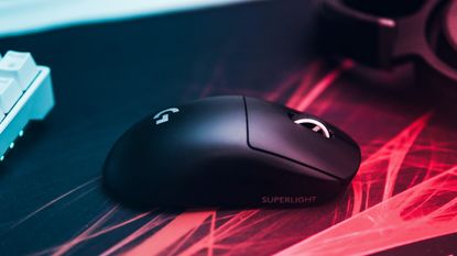Best gaming mouse 2022: Image depicts black mouse on desk with coloured lighting