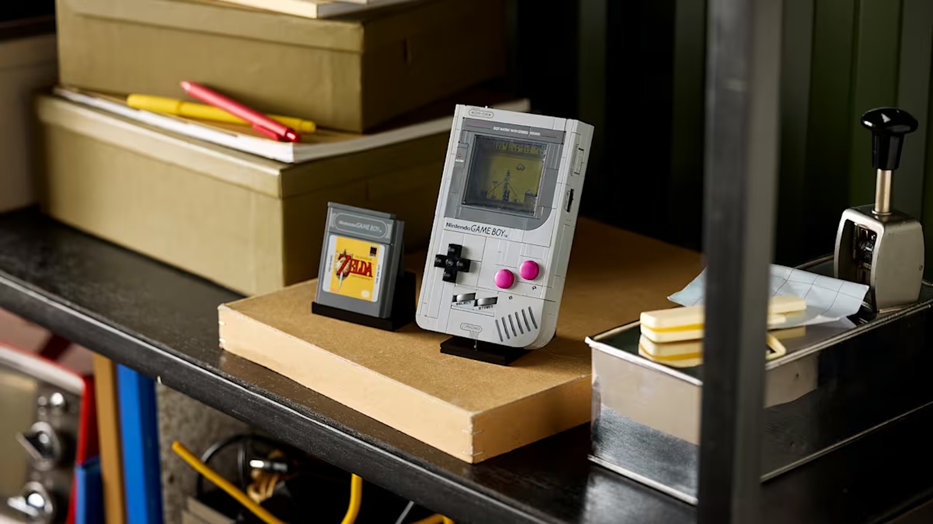 LEGO Game Boy sat on a shelf with the game cartridge next to it 
