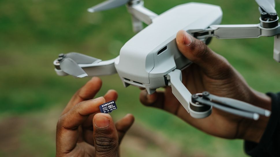 Samsung Pro Ultimate 512GB microSD being inserted into a drone