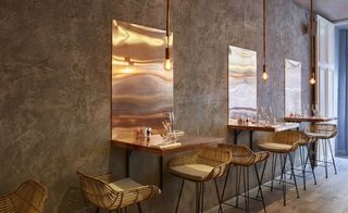 Bandol restaurant, copper tables, copper panel on wall, rattan seating and oak flooring