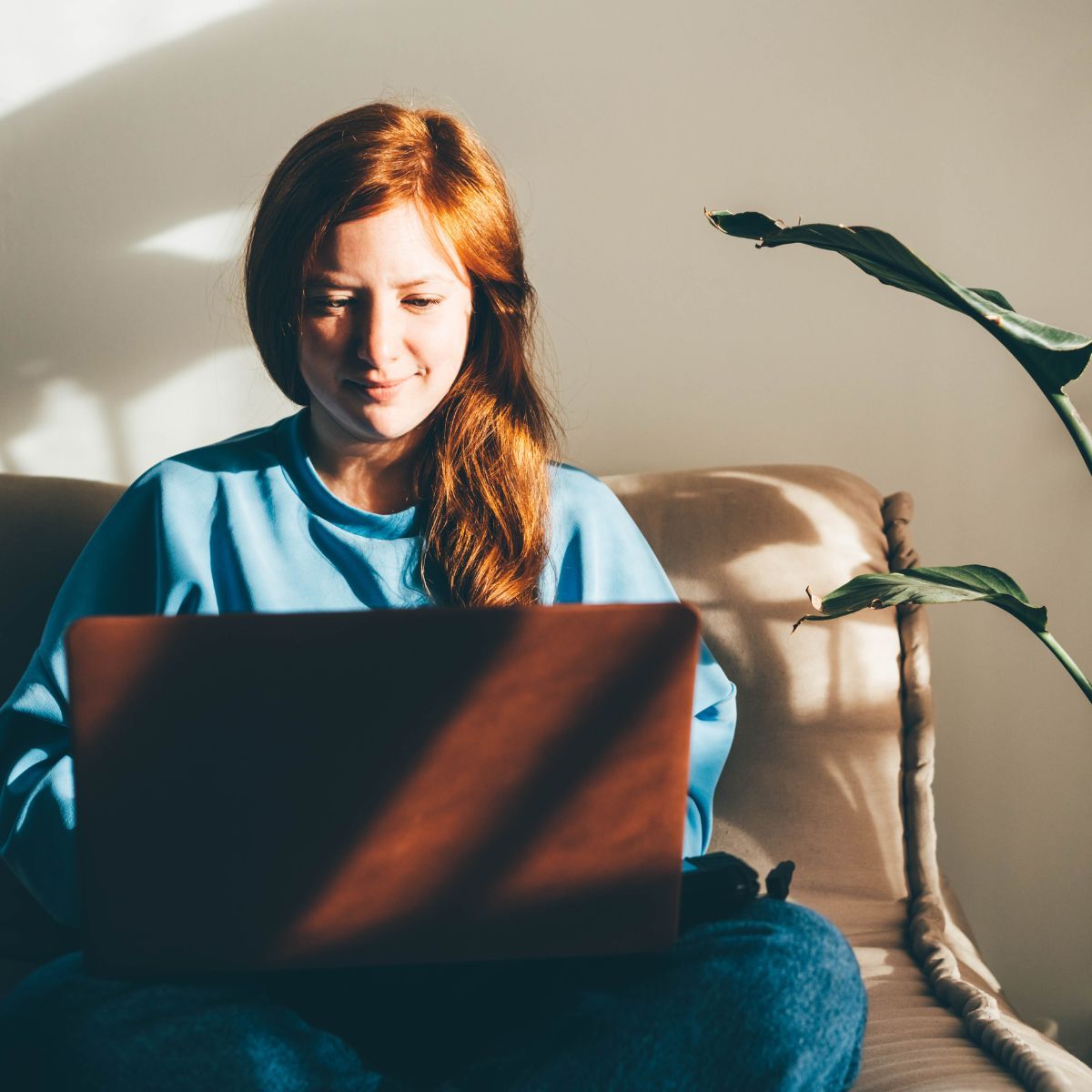 Young woman with laptop sorting her finances