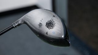 A golf club sprayed with dry shampoo showing up where the ball has struck the face