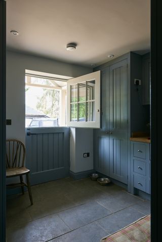 blue painted boot room with barn door