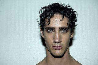 male model head shot with rumpled hair and smokey eyes