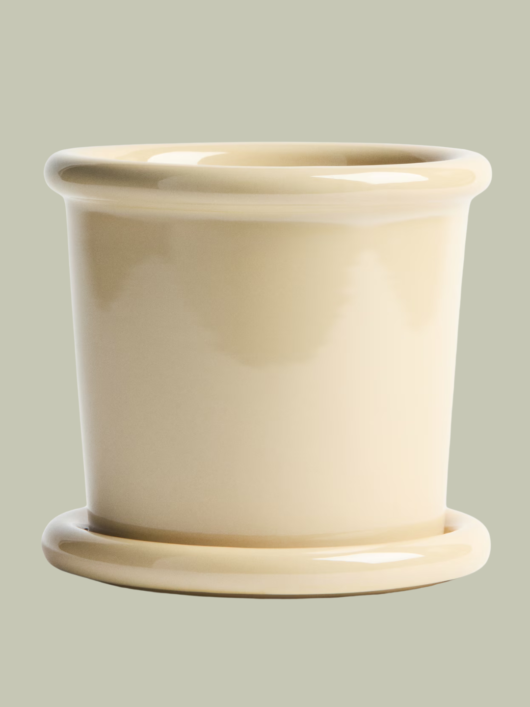 A pale yellow planter with a saucer from H&amp;amp;M