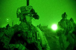 U.S. Soldiers prepare for a nighttime mission in response to an enemy rocket and mortar attack at an undisclosed Coalition and Afghan base in Afghanistan. (DoD Photo/Undated).