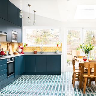 blue themed kitchen with textured flooring and drawers
