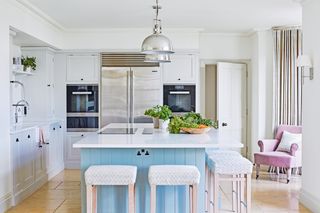 kitchen with blue kitchen island in center