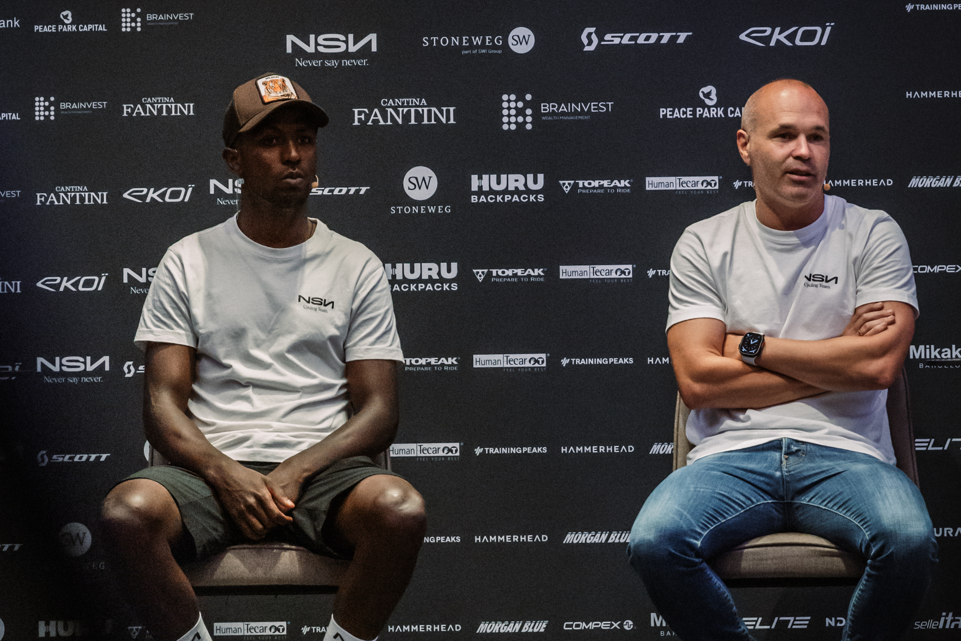 NSN Cycling Team rider Biniam Girmay on stage ahead of the Tour de France alongside World Cup winner Andrés Iniesta