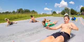 Kids from a YouTube video on a giant slip 'n slide